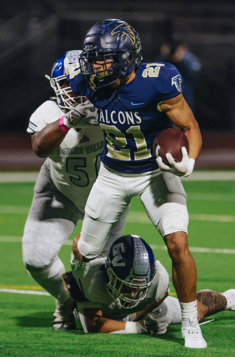 Foothill running back Avant Gates Jr. (21) makes his way past Green Valley defenders during a g ...