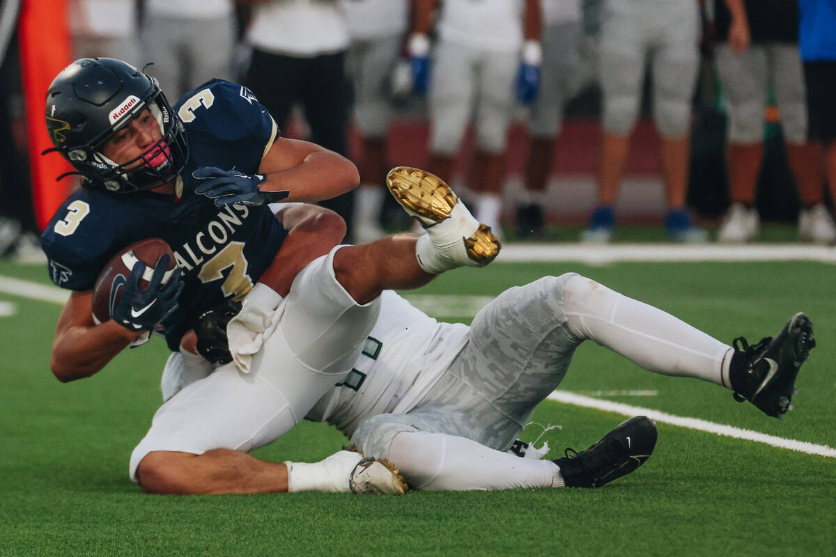 Foothill running back Eugene Altobella III (3) is taken to the ground by a Green Valley defende ...
