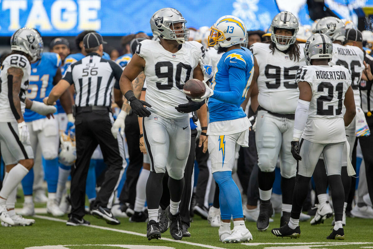 Los Angeles Chargers wide receiver Keenan Allen (13) interacts with Raiders defensive tackle Je ...