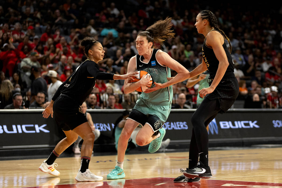 New York Liberty forward Breanna Stewart (30) drives between Las Vegas Aces forward Alysha Clar ...