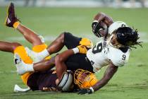 Colorado running back Anthony Hankerson (9) is tackled by Arizona State linebacker Caleb McCull ...
