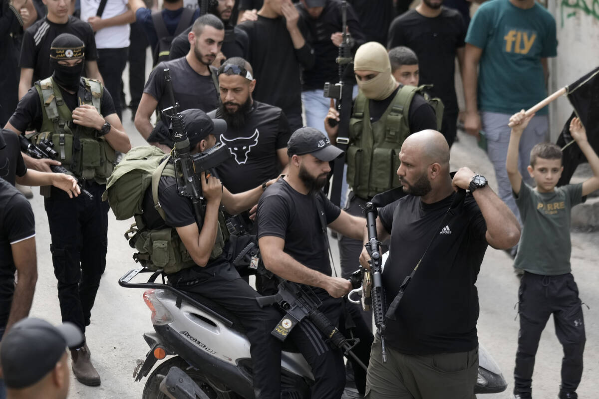 Palestinian militants attend the funeral of Ahmad Awawda, 19, who was killed in clashes with Is ...