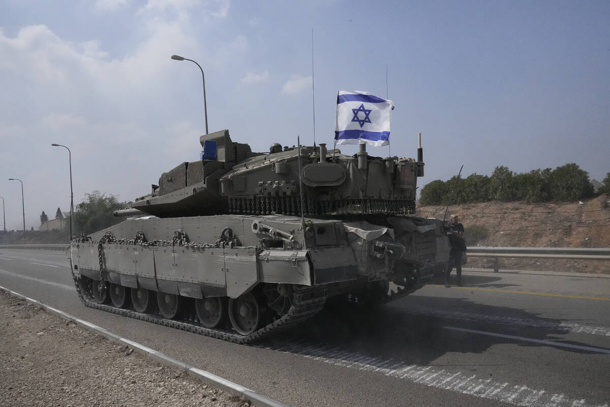 Israeli tank heads south near Sderot, Israel, Sunday, Oct.8, 2023. Hamas militants stormed over ...