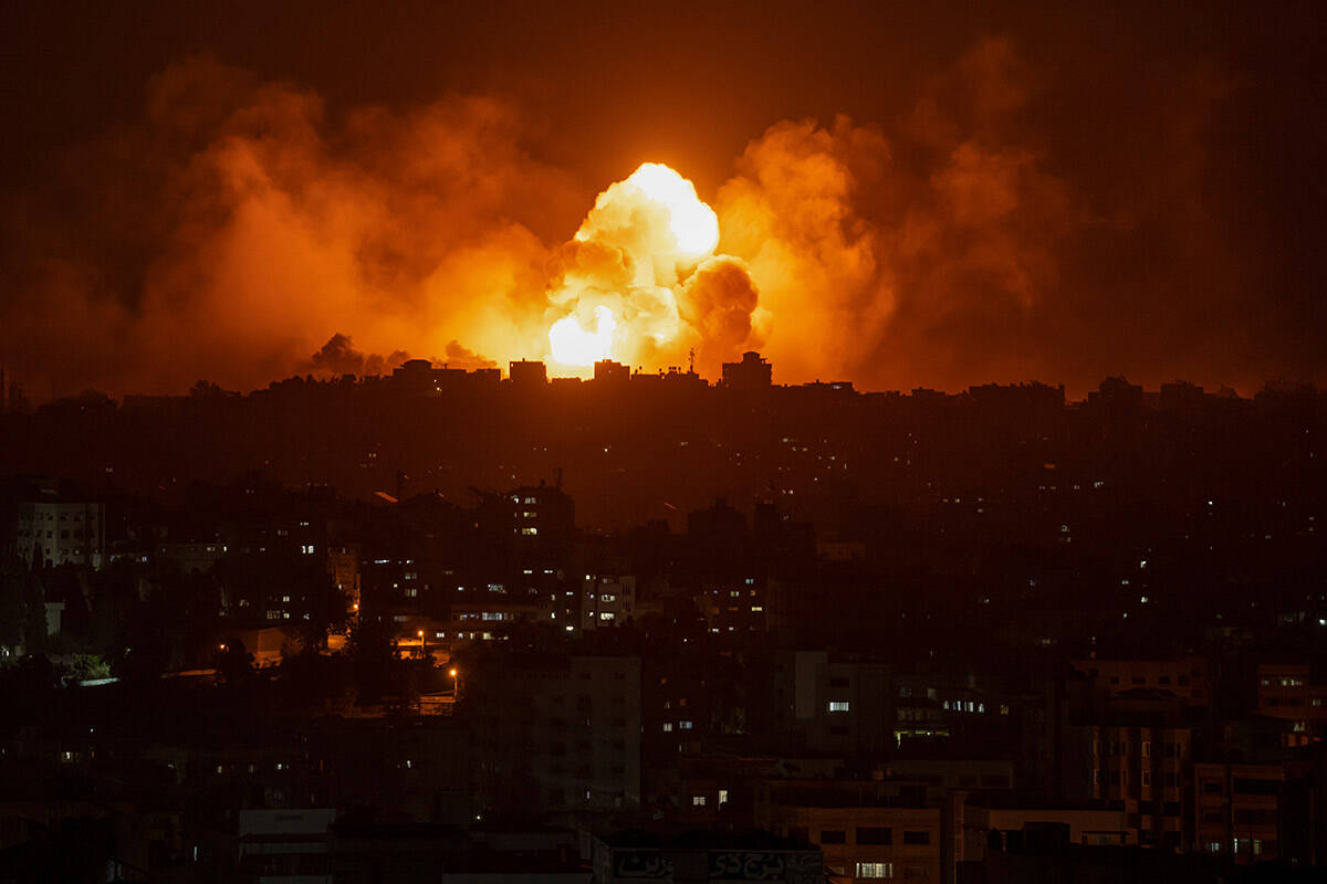 Fire and smoke rise following an Israeli airstrike, in Gaza City, Sunday, Oct. 8, 2023. The mil ...
