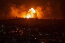 Fire and smoke rise following an Israeli airstrike, in Gaza City, Sunday, Oct. 8, 2023. The mil ...