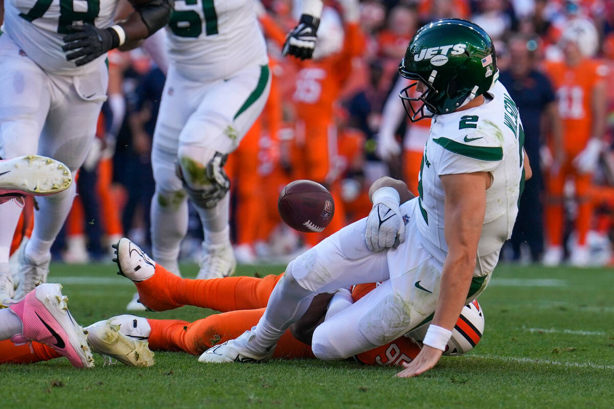 New York Jets quarterback Zach Wilson is sacked by Denver Broncos defensive tackle Elijah Garci ...