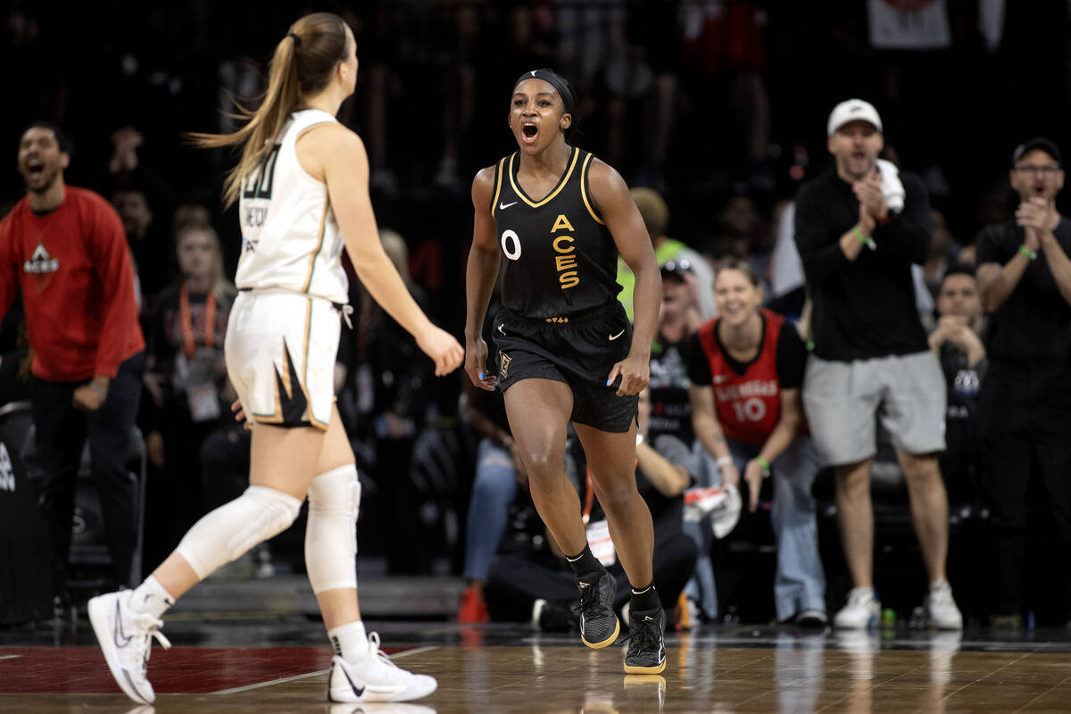 Las Vegas Aces guard Jackie Young (0) celebrates after scoring while New York Liberty guard Sab ...