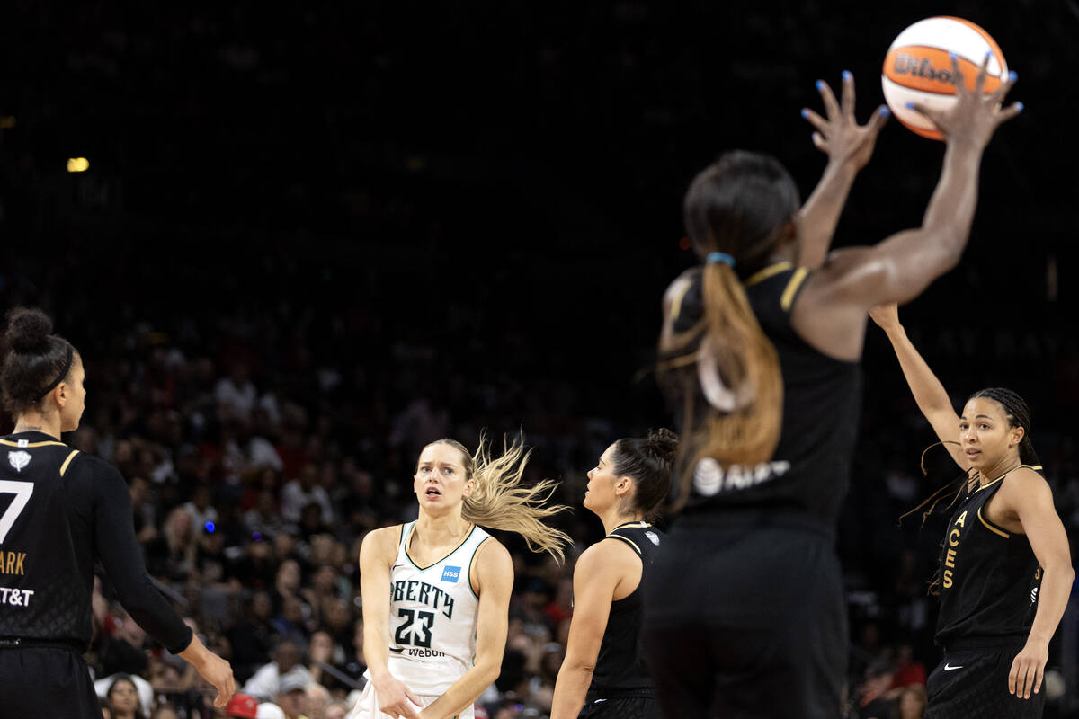 Las Vegas Aces guard Jackie Young (0) intercepts a pass by New York Liberty guard Marine Johann ...