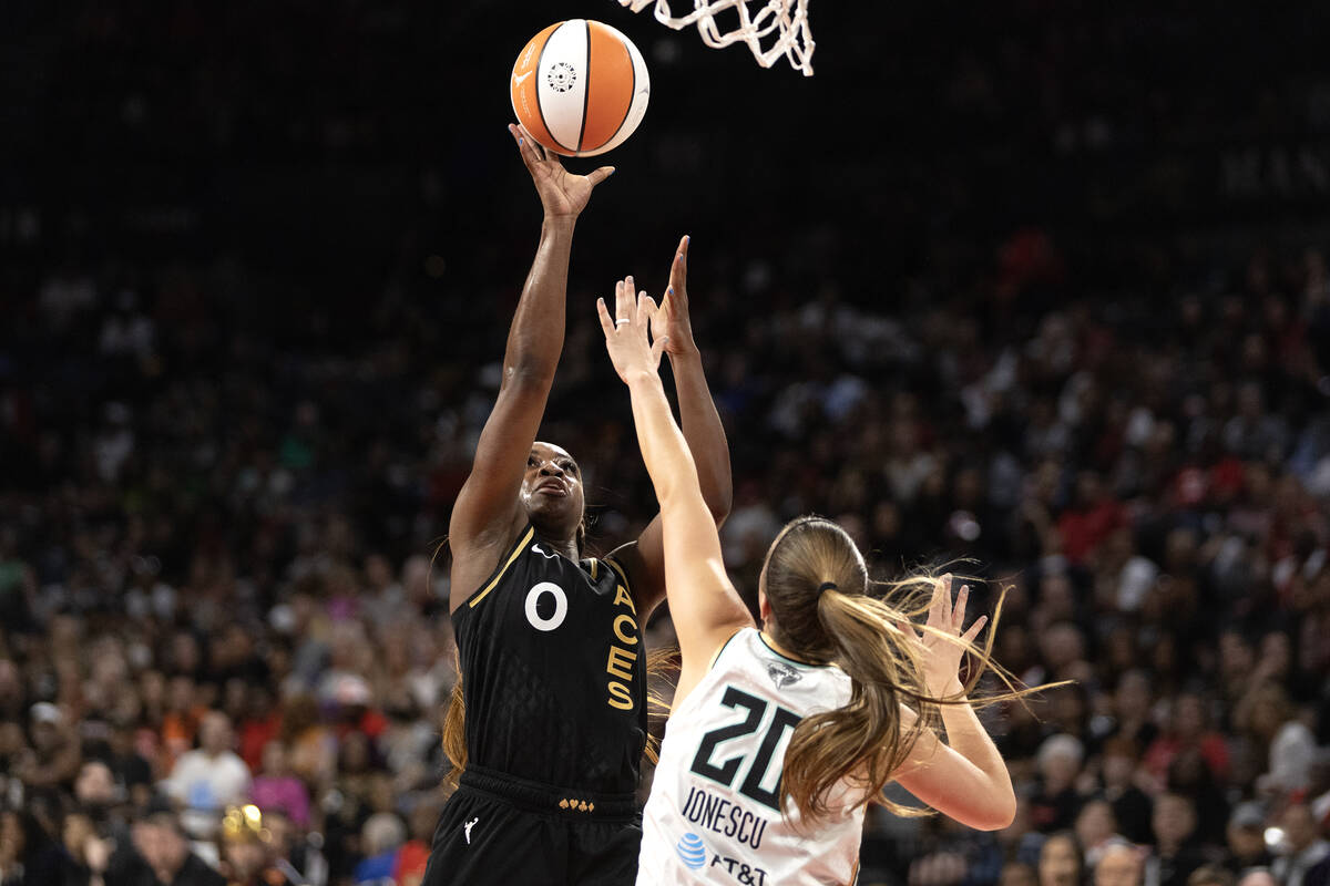 Las Vegas Aces guard Jackie Young (0) shoots against New York Liberty guard Sabrina Ionescu (20 ...