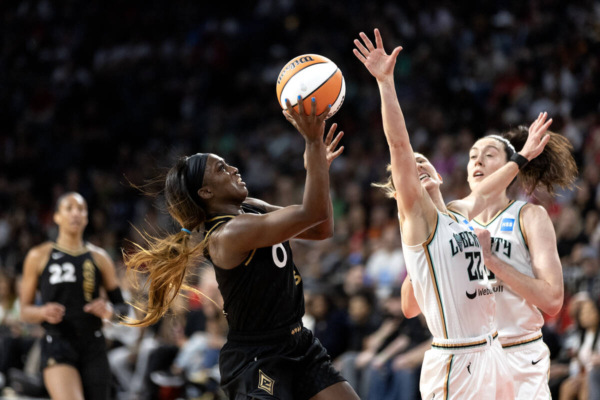 Las Vegas Aces guard Jackie Young (0) shoots against New York Liberty guard Courtney Vandersloo ...