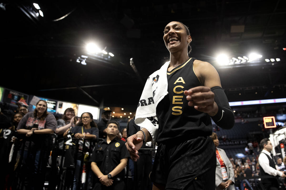 Las Vegas Aces forward A'ja Wilson (22) walks to sign autographs for fans after her team won Ga ...