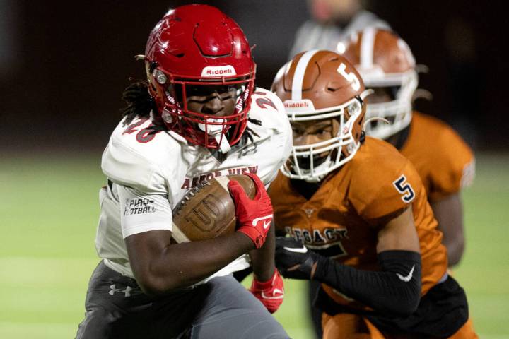 Arbor View running back Nylen Johnson (28) secures enough yards for a first down while Legacy c ...