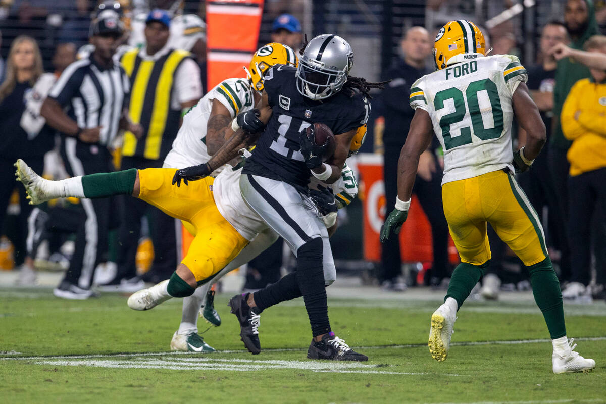 Raiders wide receiver Davante Adams (17) makes a catch as Green Bay Packers linebacker Isaiah M ...