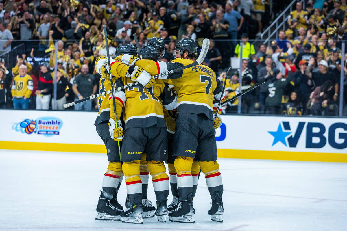 Golden Knights players celebrate a goal against the Seattle Kraken during the first period of t ...