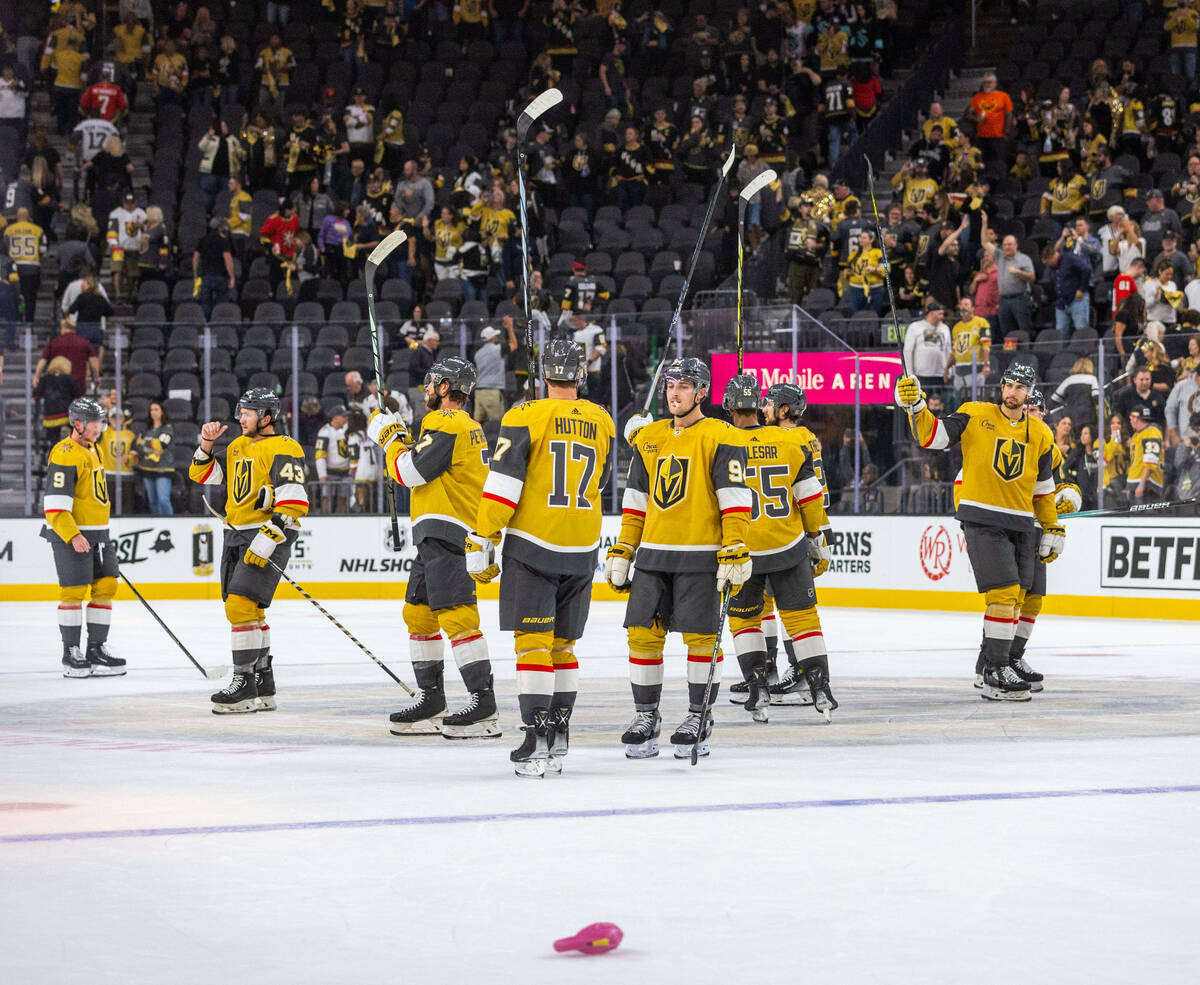 Golden Knights players celebrate their 4-1 win over the Seattle Kraken following the third peri ...