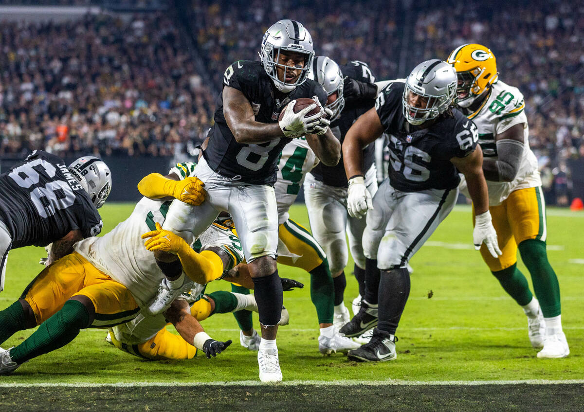 Raiders running back Josh Jacobs (8) extends over the goal line for a touchdown with Green Bay ...
