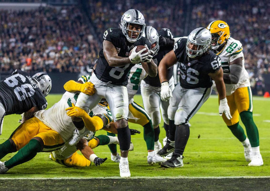 Raiders running back Josh Jacobs (8) extends over the goal line for a touchdown with Green Bay ...