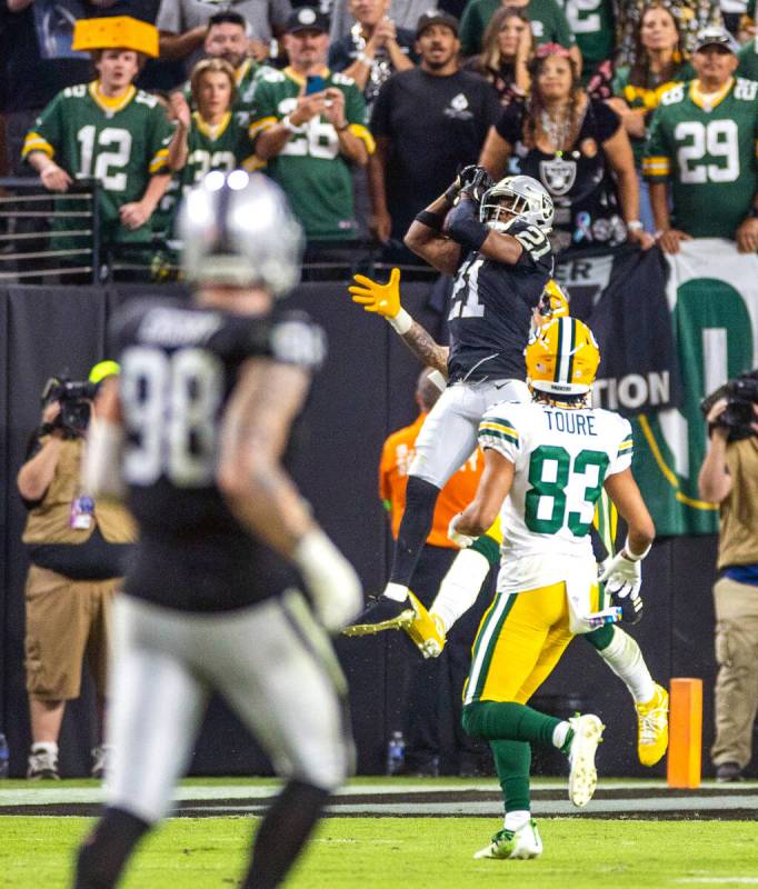 Raiders cornerback Amik Robertson (21) intercepts a pass in the end zone intended for Green Bay ...