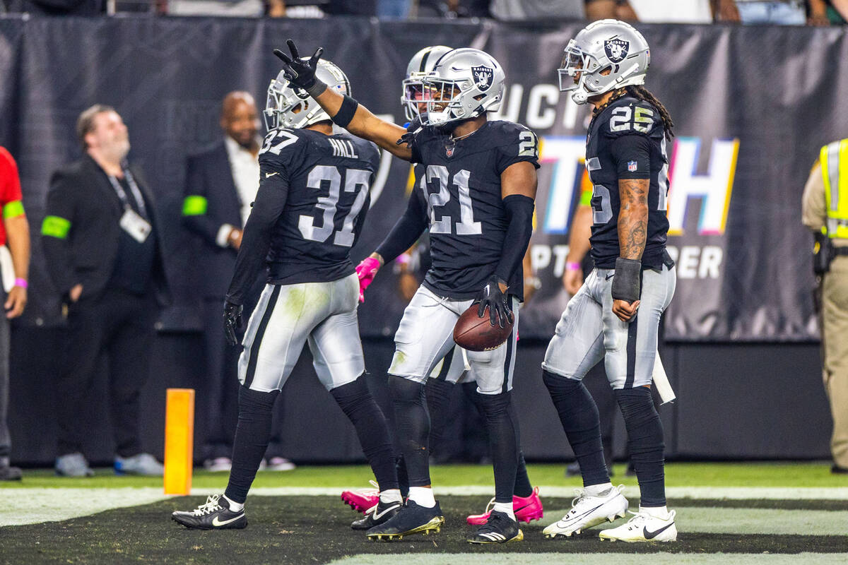 Raiders cornerback Amik Robertson (21) celebrates an interception with teammates intended for G ...