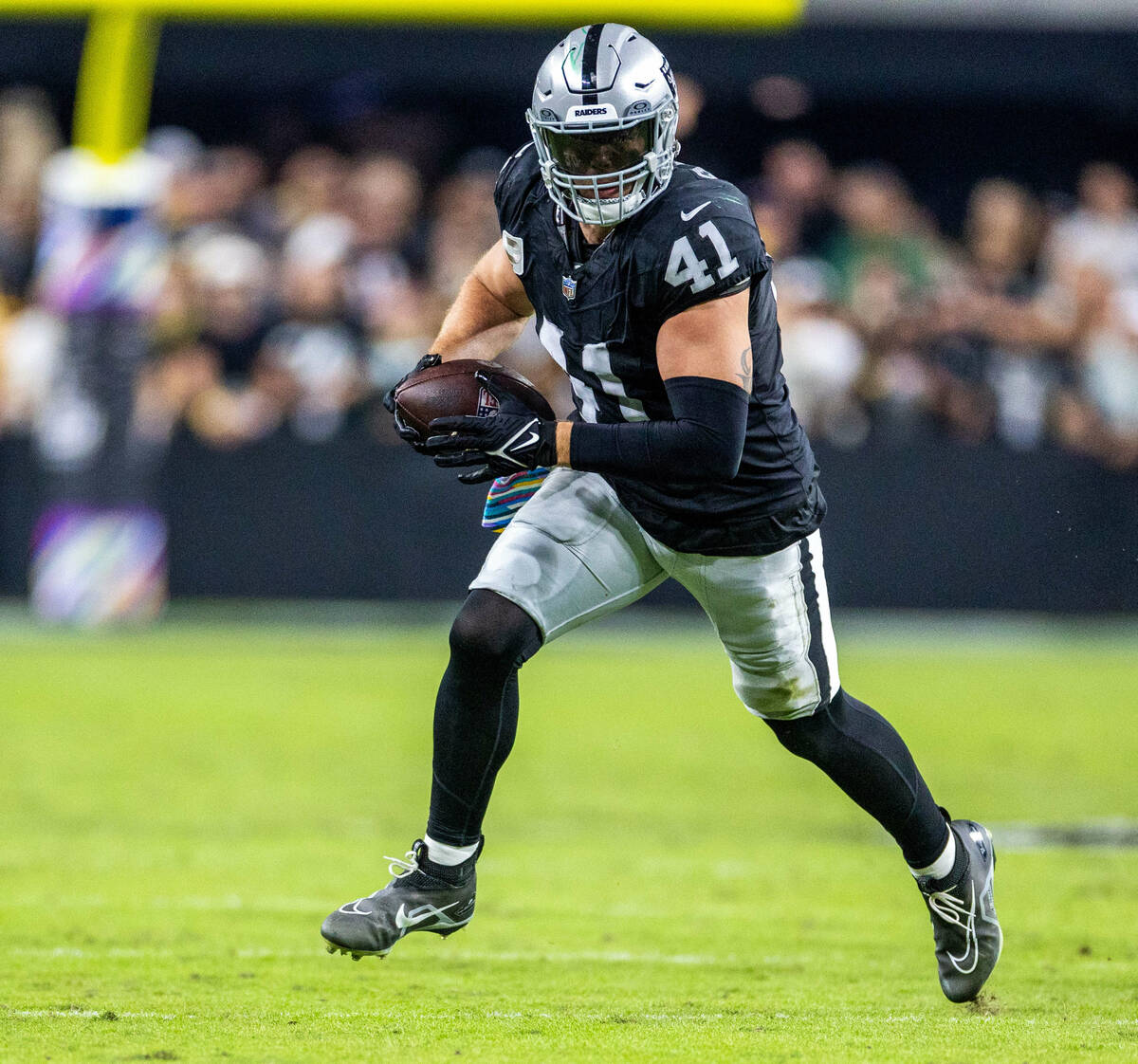 Raiders linebacker Robert Spillane (41) runs back an interception against the Green Bay Packers ...