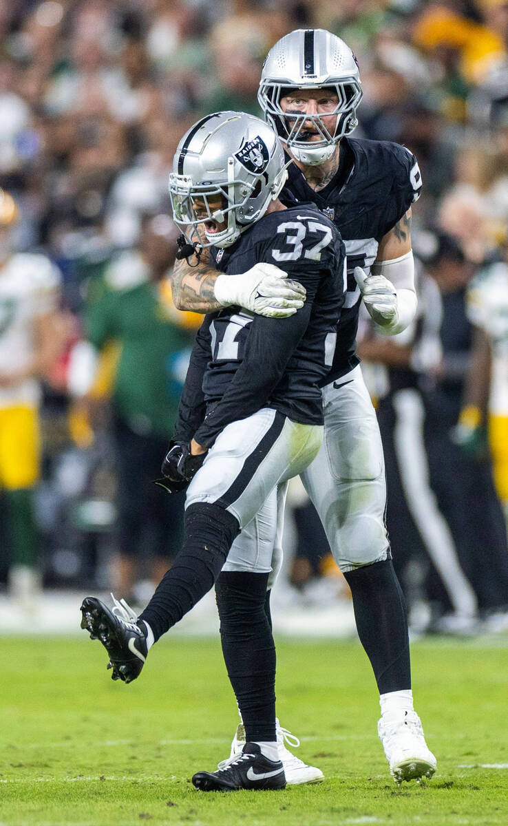 Raiders cornerback Tyler Hall (37) is pumped with teammate defensive end Maxx Crosby (98) as th ...
