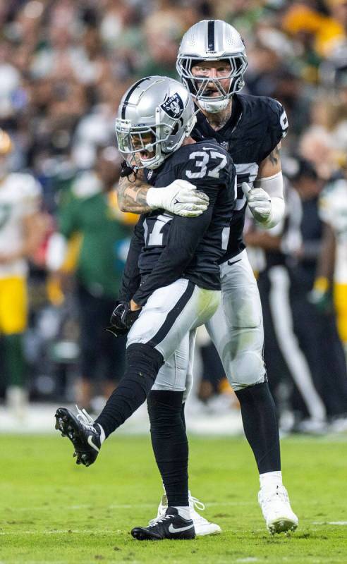 Raiders cornerback Tyler Hall (37) is pumped with teammate defensive end Maxx Crosby (98) as th ...
