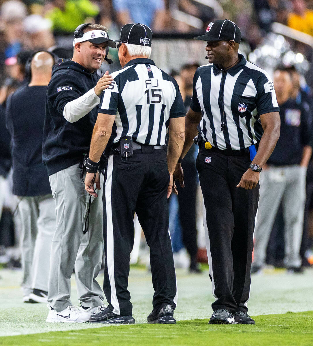 Raiders head coach Josh McDaniels chats with officials on the sidelines against the Green Bay P ...