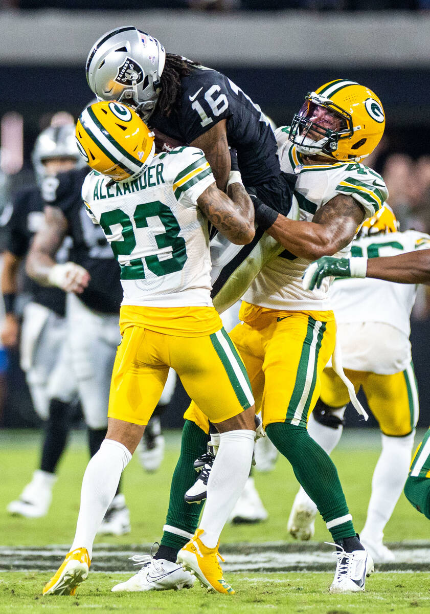 Raiders wide receiver Jakobi Meyers (16) secures a pass between Green Bay Packers cornerback Ja ...