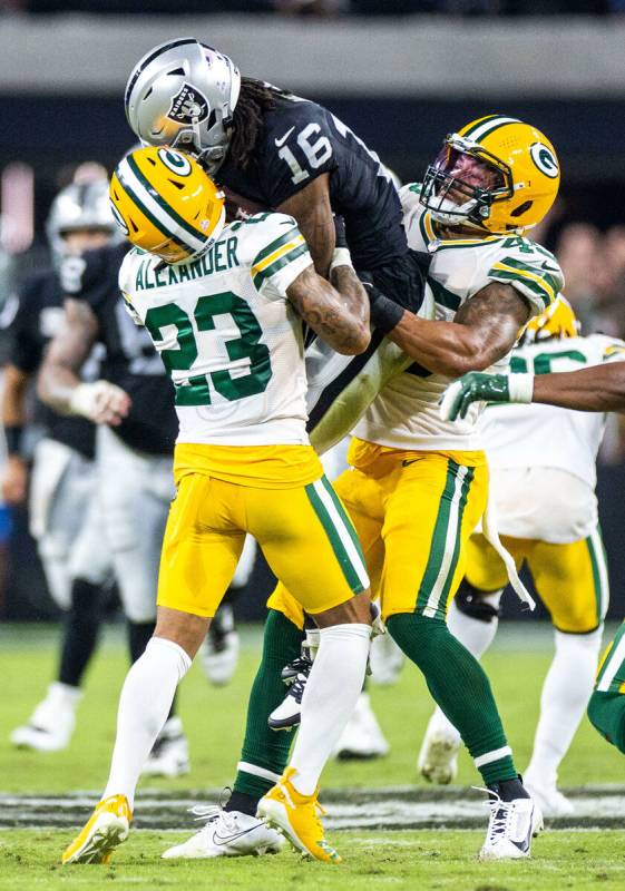 Raiders wide receiver Jakobi Meyers (16) secures a pass between Green Bay Packers cornerback Ja ...