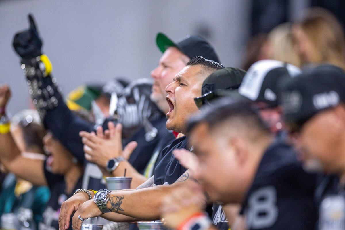 Raiders fans cheer against the Green Bay Packers during the first half of their NFL game at All ...