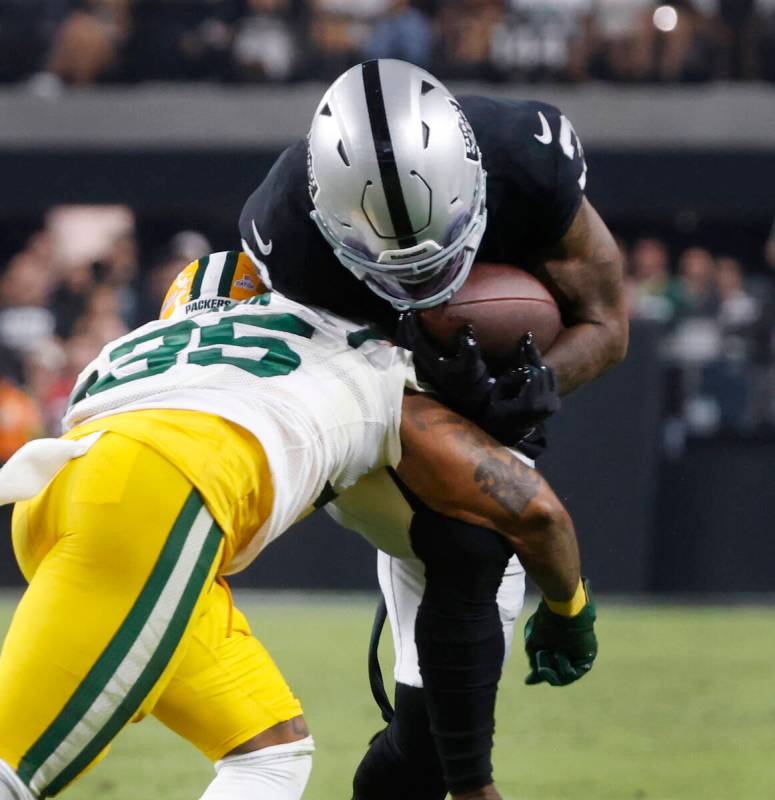 Raiders wide receiver DeAndre Carter (3) is tackled by the Green Bay Packers cornerback Corey B ...