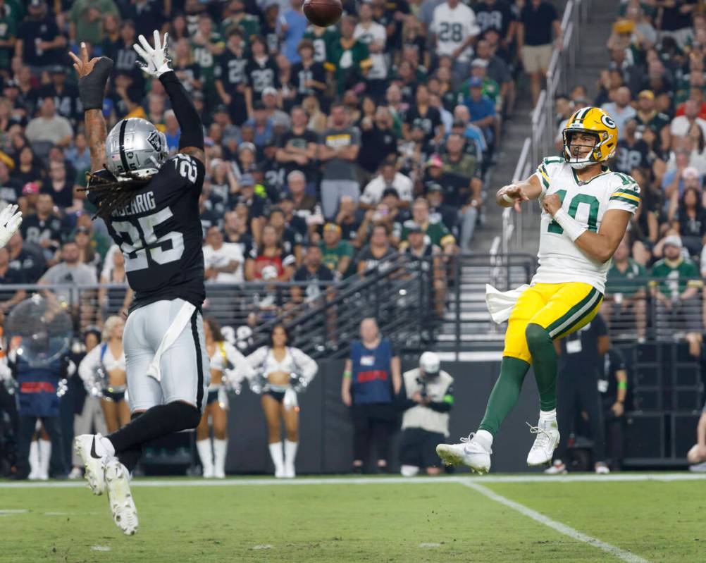 Green Bay Packers quarterback Jordan Love (10) throws under pressure from Raiders safety Tre'vo ...