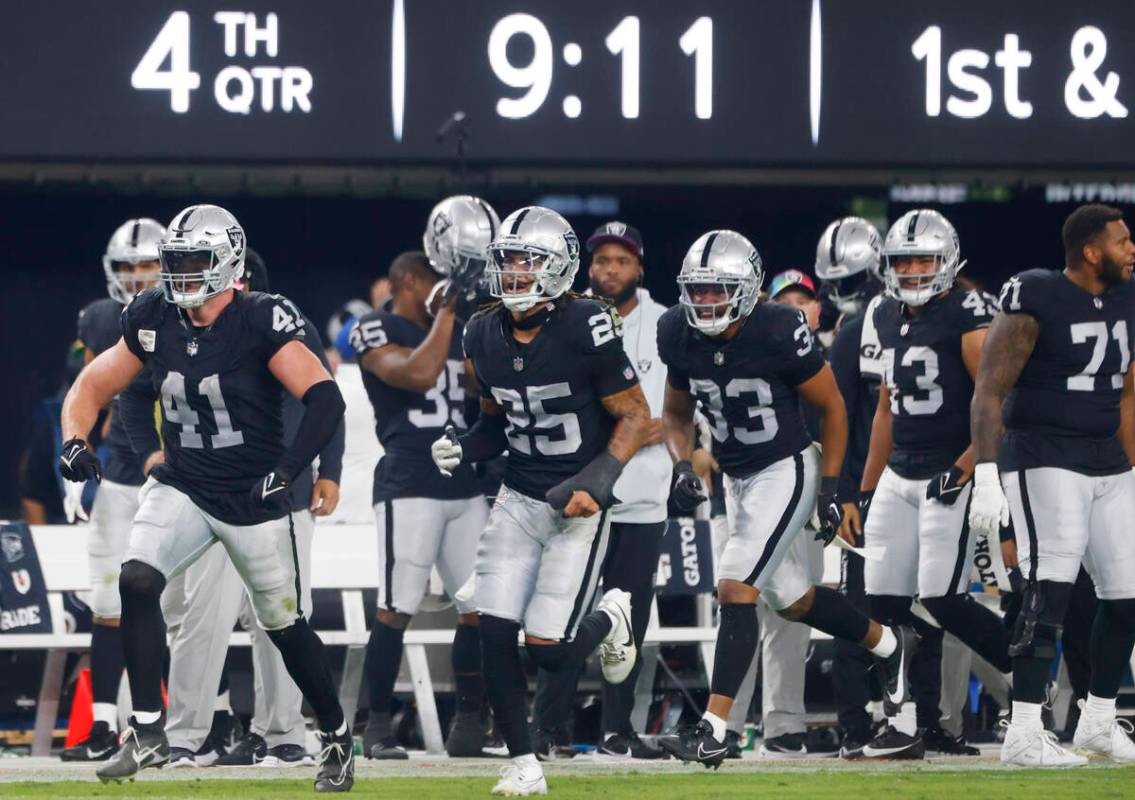 Raiders linebacker Robert Spillane (41) celebrates his second interception of the game with his ...