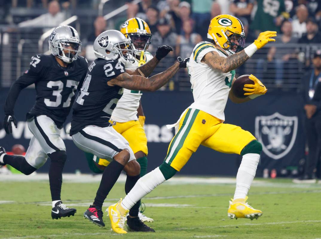 The Green Bay Packers wide receiver Christian Watson (9) is taken down by Raiders cornerback Ma ...