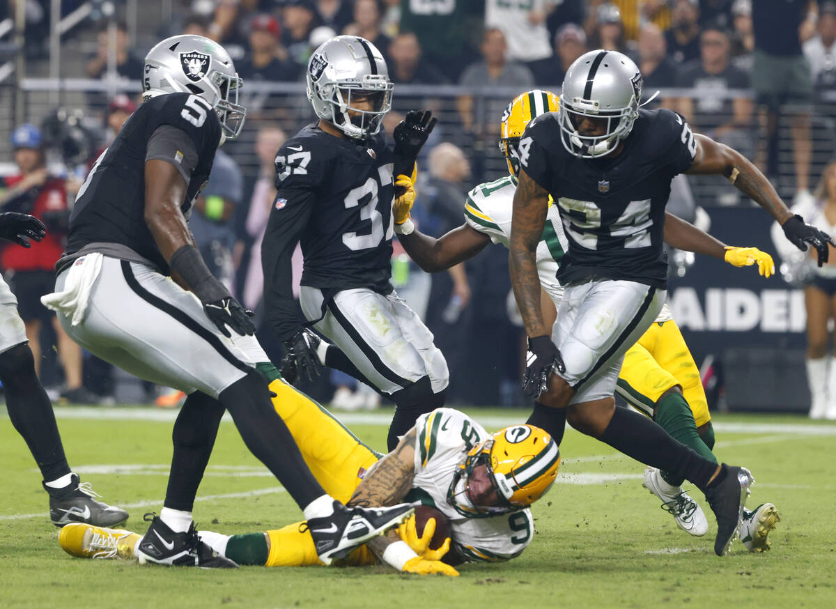 The Green Bay Packers wide receiver Christian Watson (9) is taken down by Raiders cornerback Ma ...