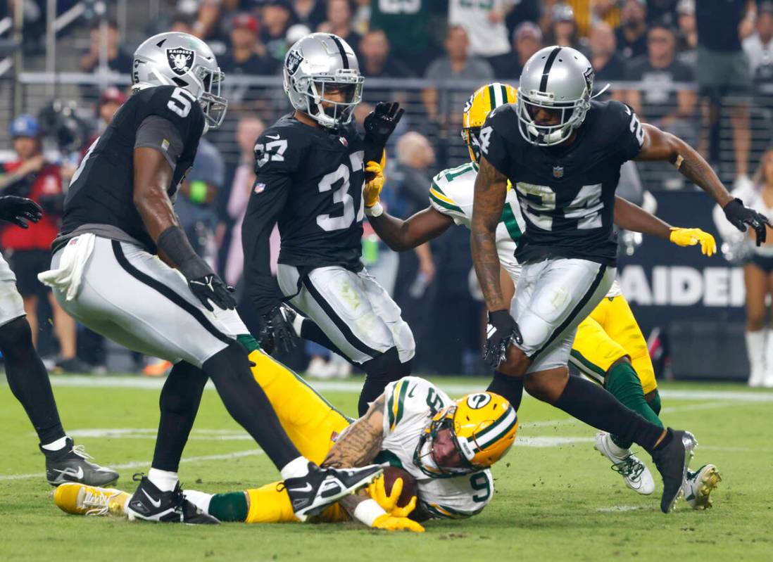 The Green Bay Packers wide receiver Christian Watson (9) is taken down by Raiders cornerback Ma ...