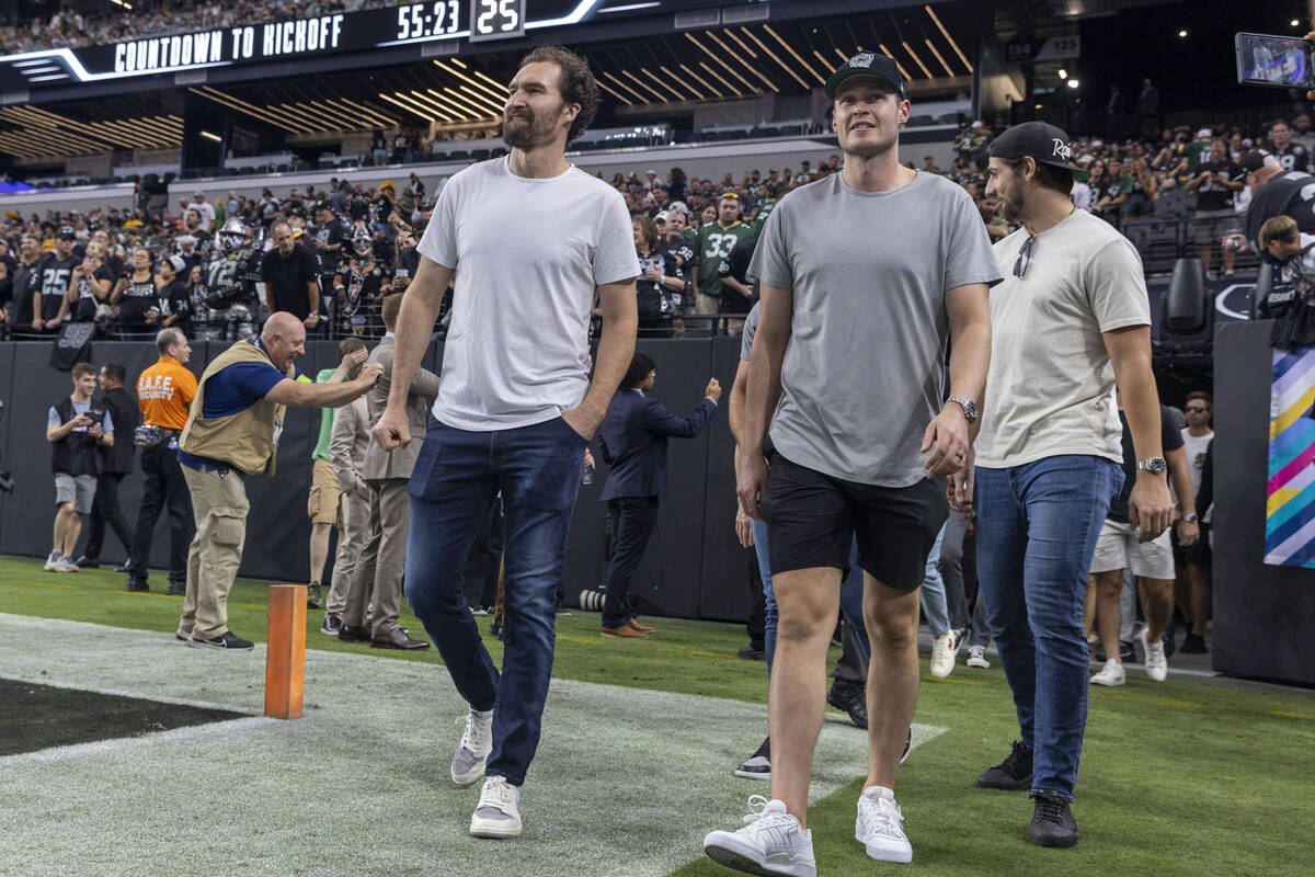 Golden Knights players from left, Mark Stone, Brayden McNabb and Nicolas Roy take the field bef ...