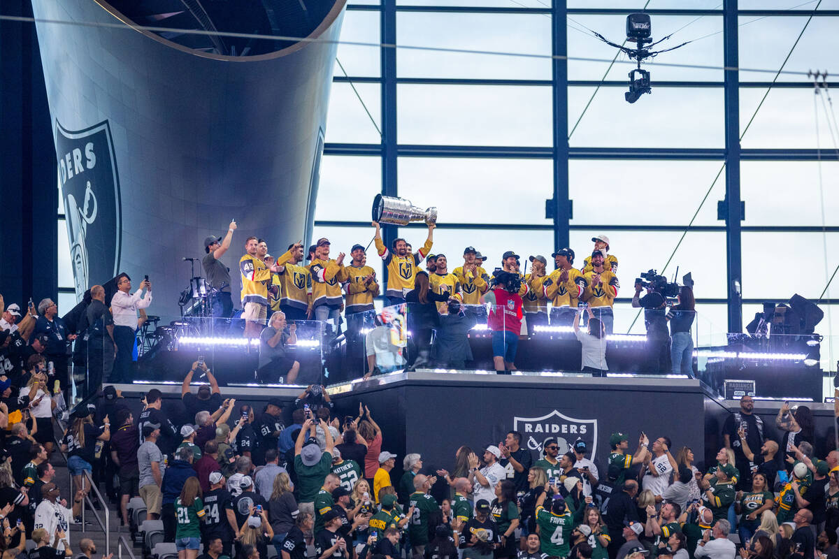 The Golden Knights with the Stanley Cup in the air for the torch lighting as the Raiders face t ...