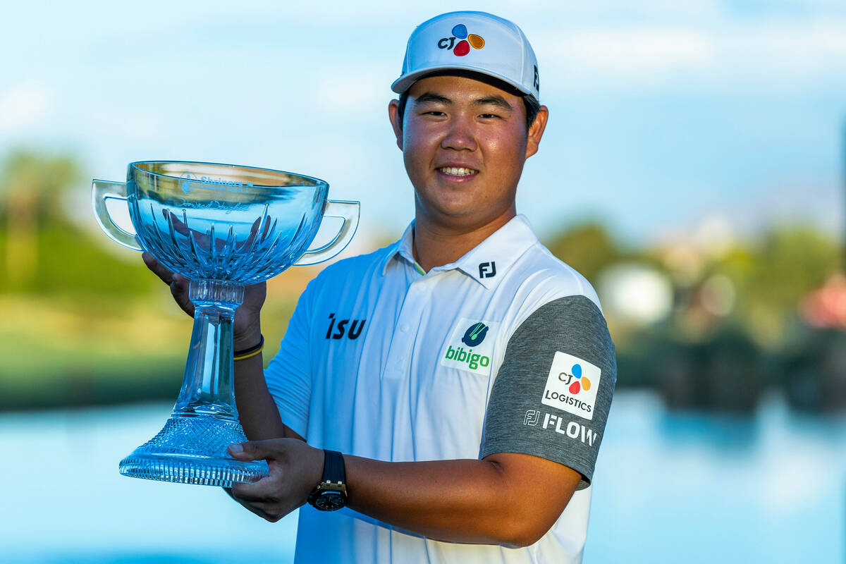 holding trophy shirt