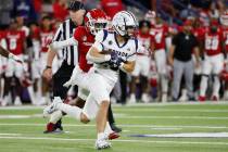Nevada wide receiver Spencer Curtis looks to get past a Fresno State defender during the first ...