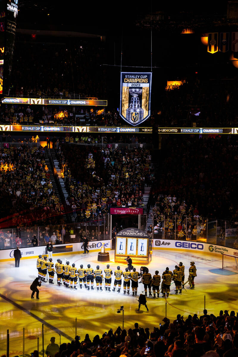 Golden Knights players gather during the raising of the 2023 Stanley Cup Championship banner be ...