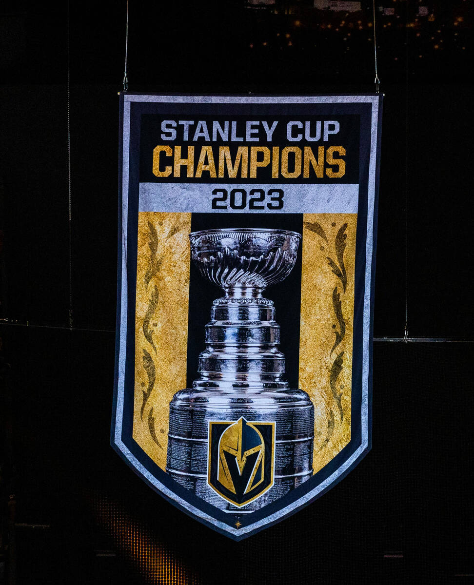 The 2023 Stanley Cup Championship banner rises before the NHL opening night game with the Golde ...