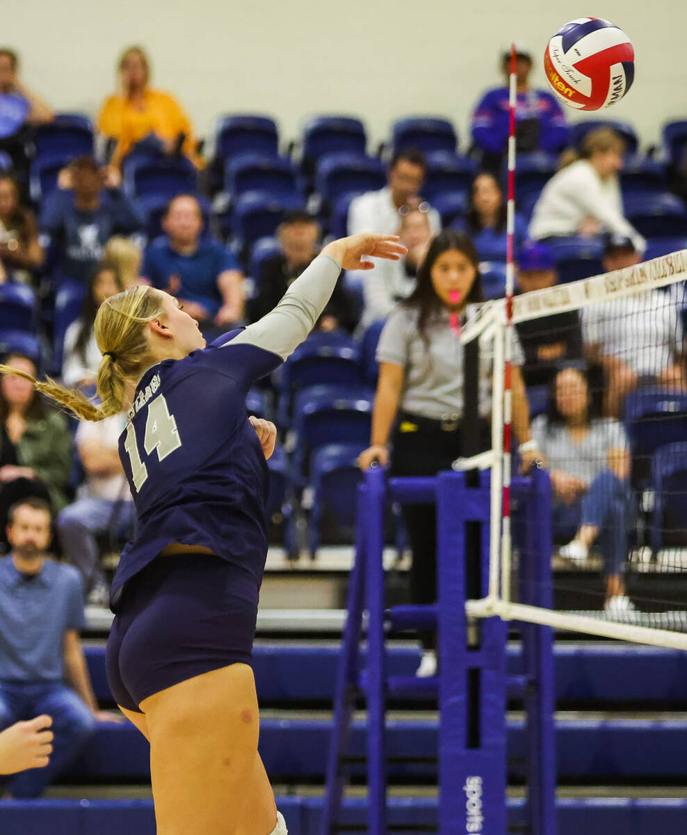 Shadow Ridge middle blocker Bree Farrimond (14) hits the ball over the net during a match again ...
