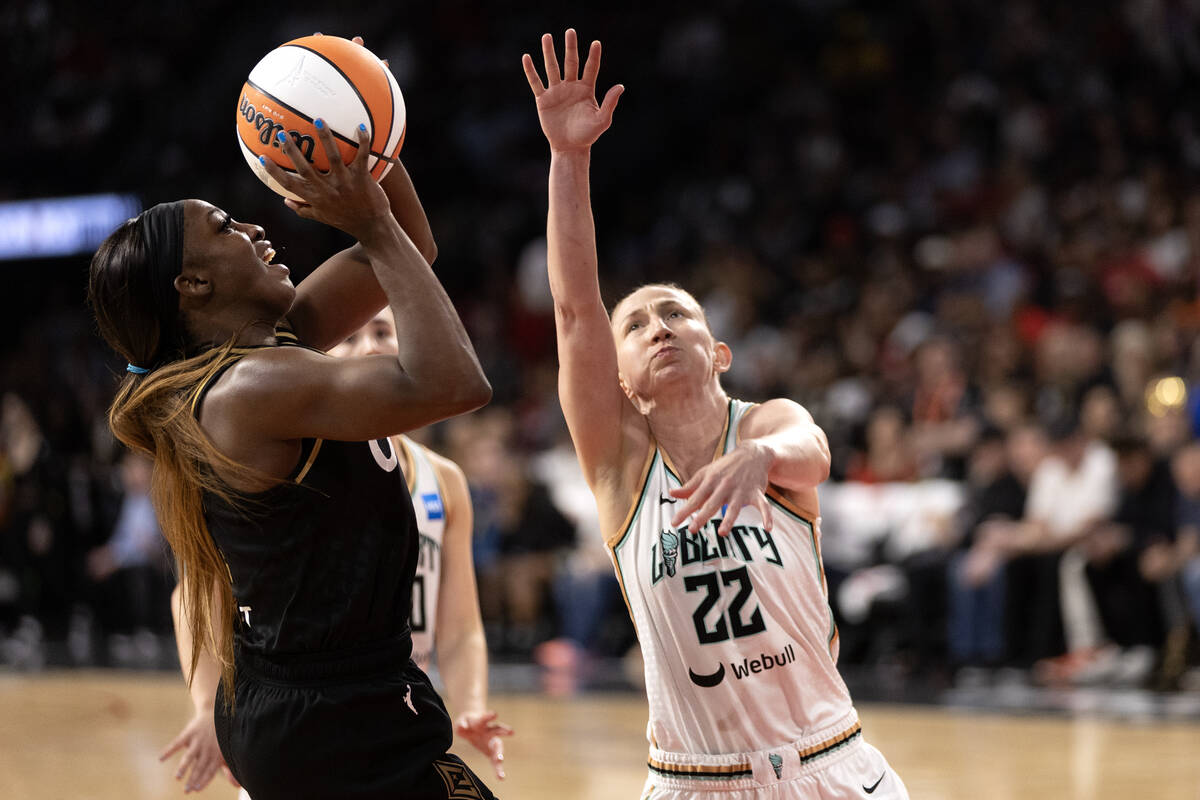 Las Vegas Aces guard Jackie Young (0) shoots against New York Liberty guard Courtney Vandersloo ...