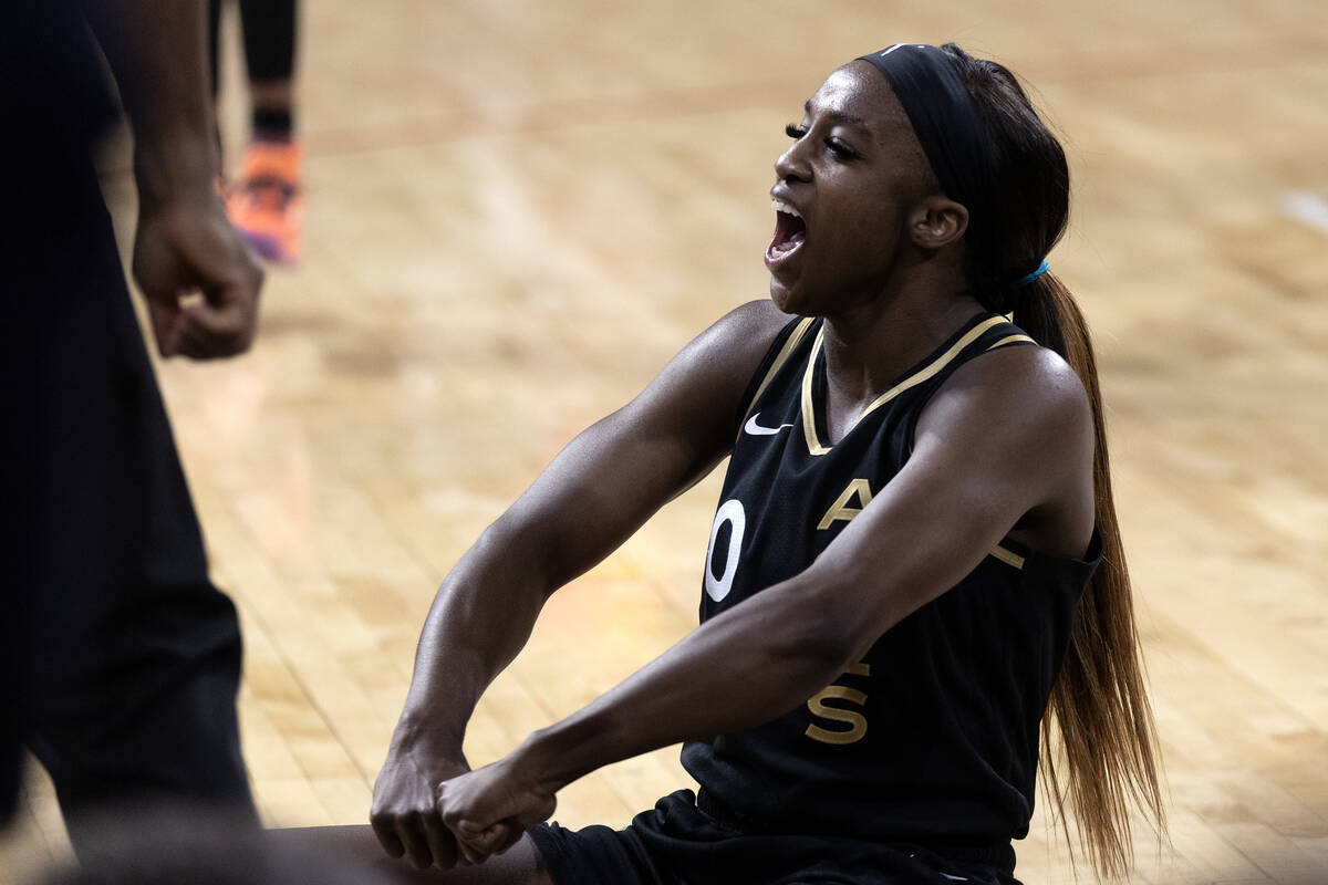 Las Vegas Aces guard Jackie Young (0) celebrates after scoring while falling to the court durin ...