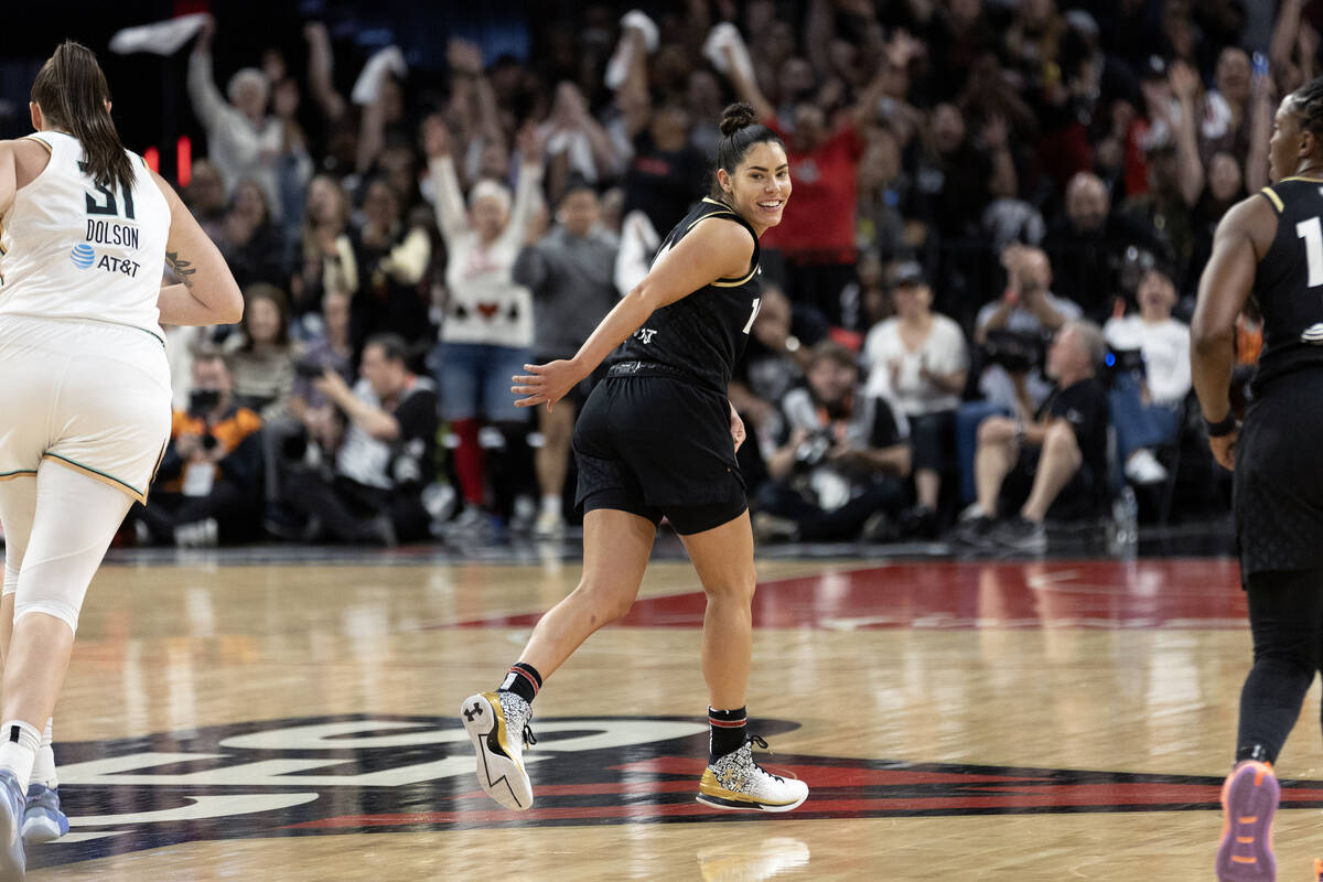 Las Vegas Aces guard Kelsey Plum (10) smiles at her teammates after hitting a three-pointer dur ...