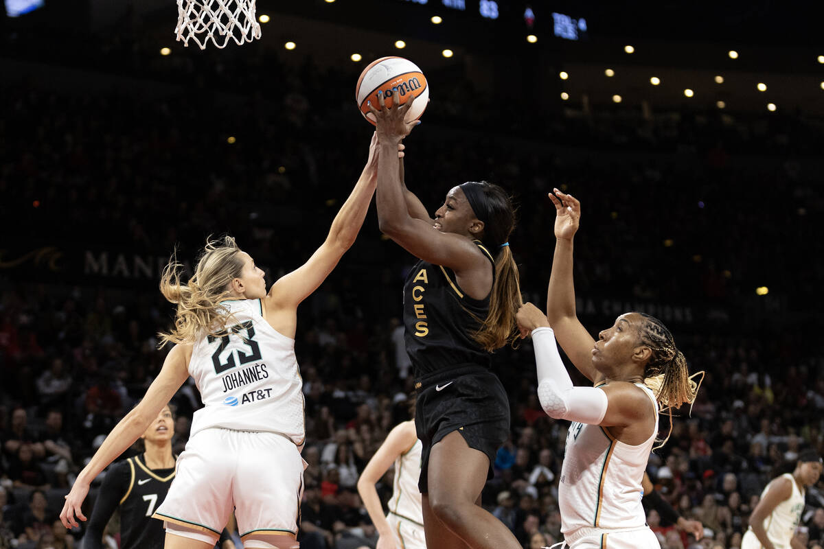 Las Vegas Aces guard Jackie Young (0) jumps for a rebound against New York Liberty guard Marine ...