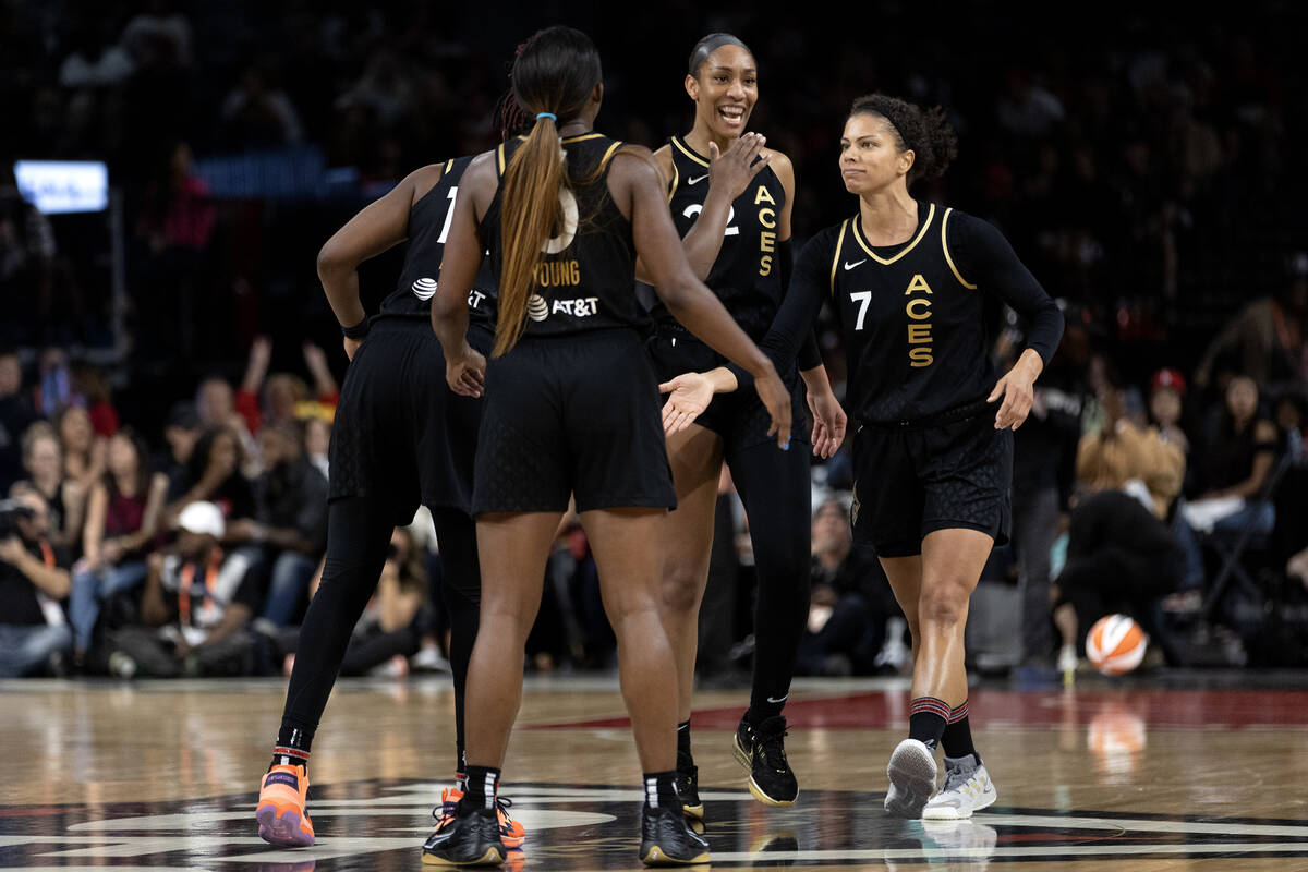 The Las Vegas Aces gather to celebrate after scoring during the second half in Game 2 of a WNBA ...
