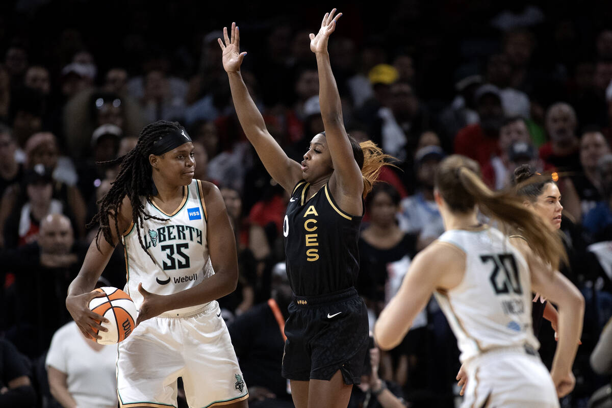 Las Vegas Aces guard Jackie Young (0) defends against New York Liberty forward Jonquel Jones (3 ...