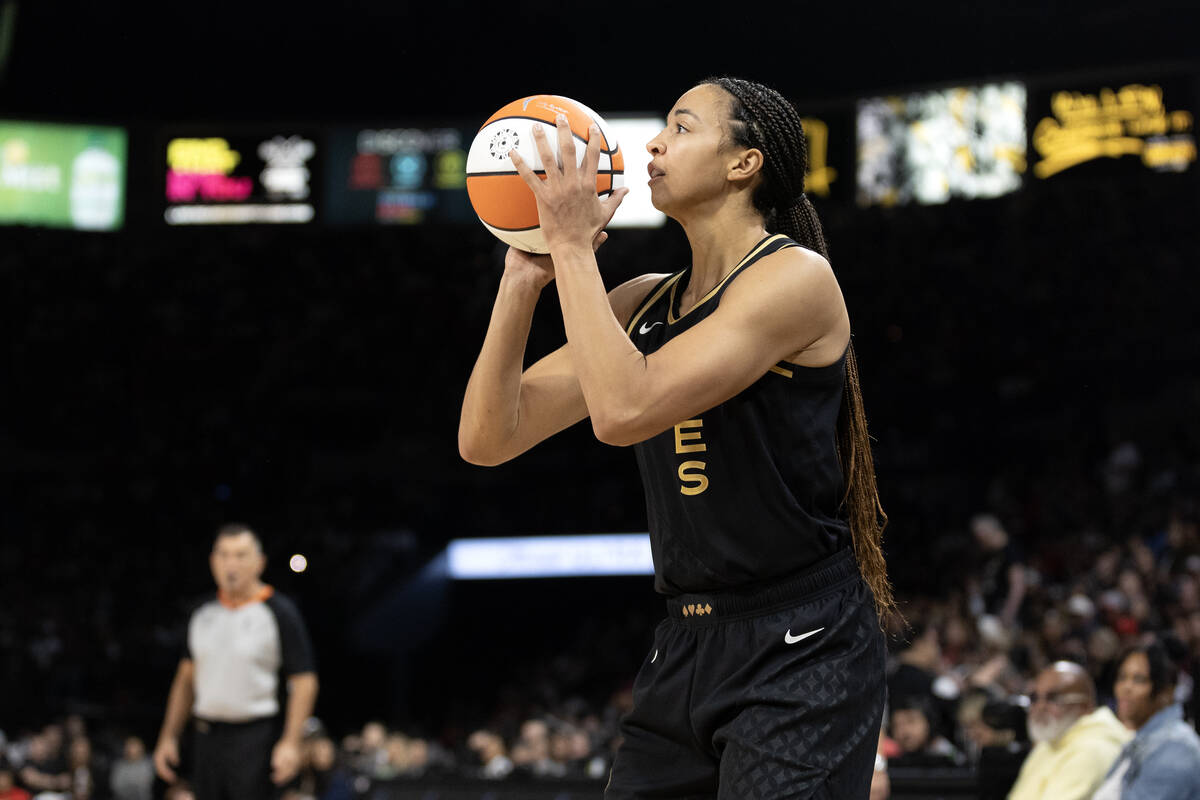 Las Vegas Aces center Kiah Stokes (41) bends to shoot a three-pointer during the first half in ...